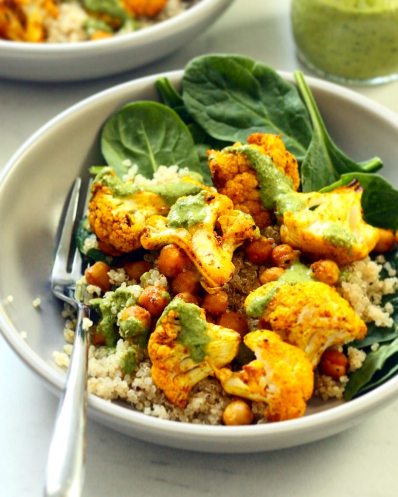 Golden Cauliflower Bites serviced over a grain bowl with spinach.