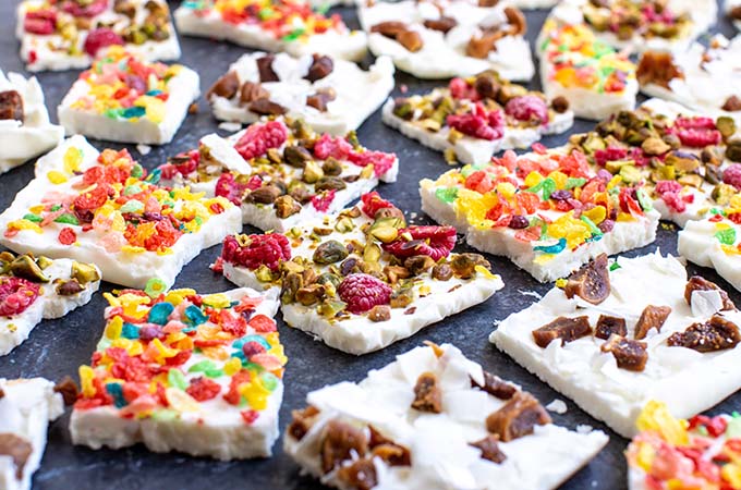 Greek Yogurt Bark Varieties Cut into Squares and Spread on Table