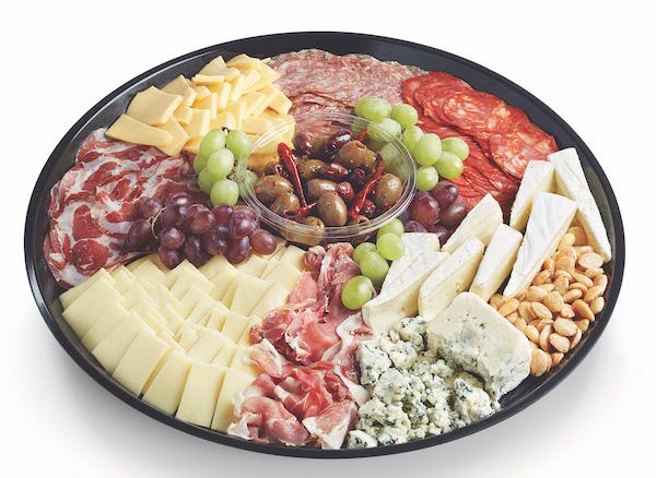 A charcuterie tray with grapes, olives, nuts, and assorted cheeses and cured meats.