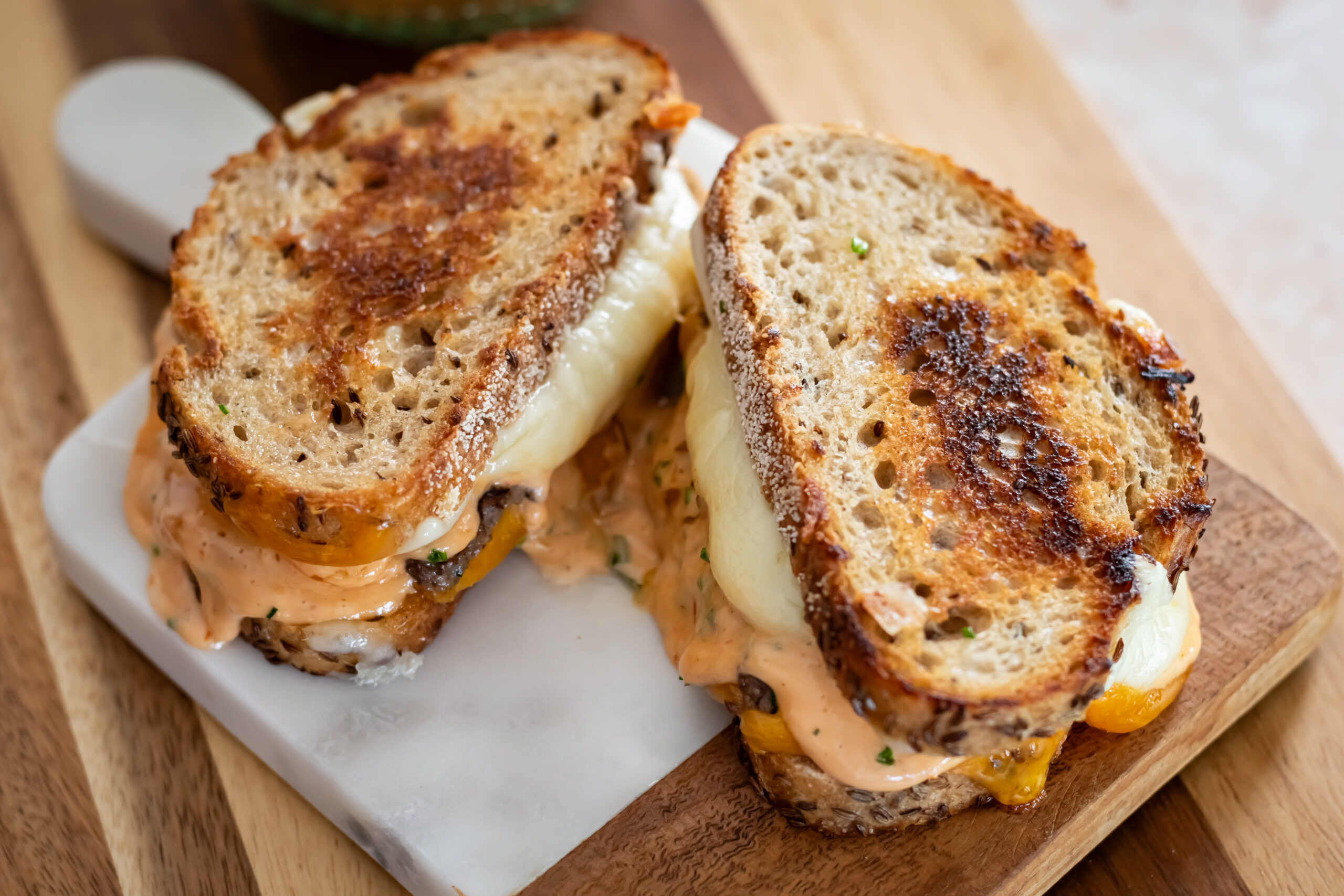 Beef Patty Melt served on a wooden block