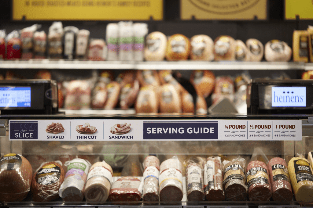 Heinen's deli serving guide branding on the outside of the deli case