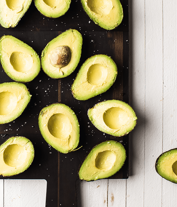 Sliced Avocados on a Black Stone Cutting Board
