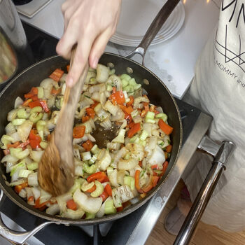Bok choy and peppers cooking in pan