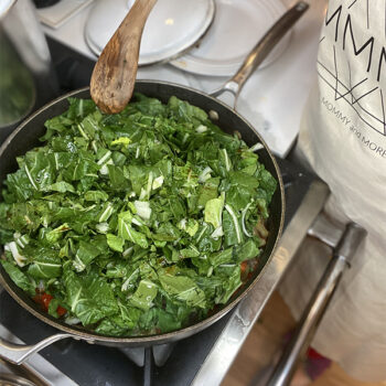 Bok choy cooking in a pan