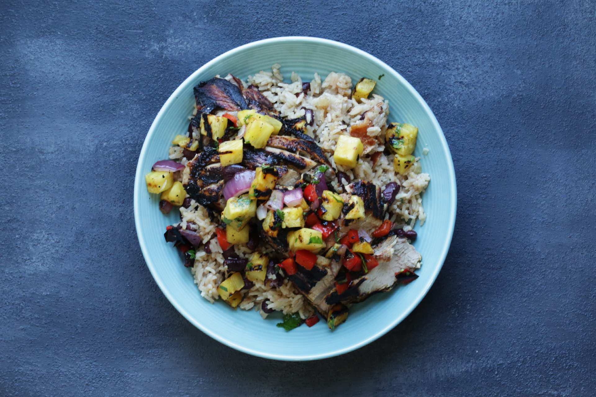 Plated Grilled Mojo Pork Tenderloin with Caribbean Rice and Beans