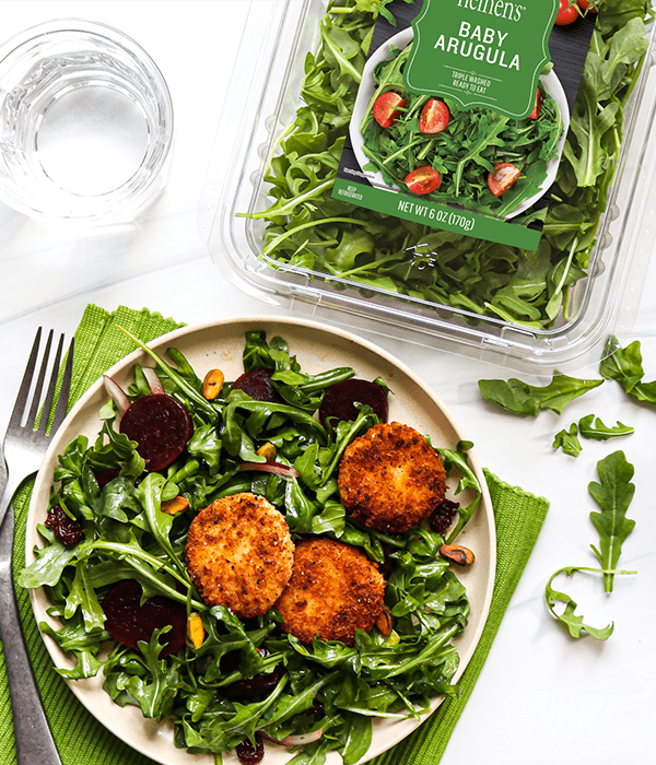 The Crispy Goat Cheese, Beet & Arugula Salad is plated alongside the Heinen's arugula