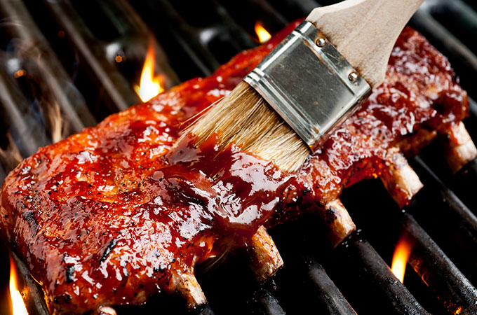 BBQ Sauce Being Brushed on Ribs