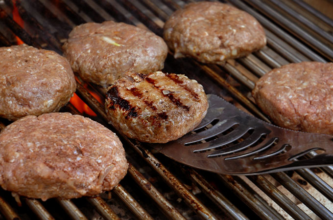 Burgers Flipping on the Grill