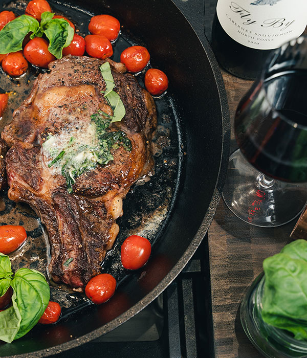 Basil Butter Ribeye Steaks with Charred Cherry Tomatoes