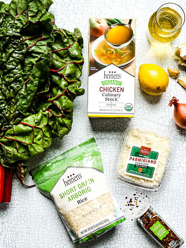 Spread of ingredients including chard, chicken stock, lemon, shallots, garlic, olive oil, short grain rice, and parmigiano Reggiano.