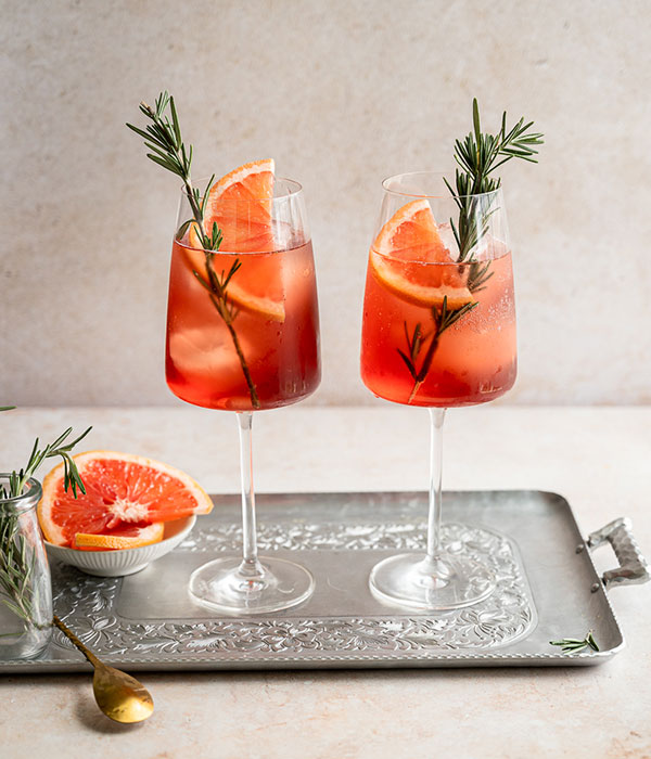 Sparkling Rose Paloma in Wine Glasses on a Silver Serving Tray