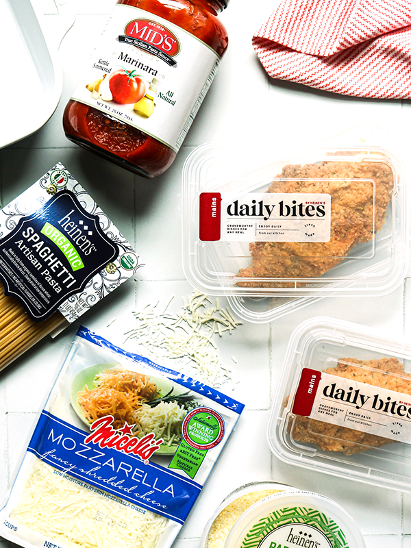 Ingredients for Chicken Parm including pasta noodles, marinara sauce, mozzarella cheese, parmesan cheese, and cooked chicken.