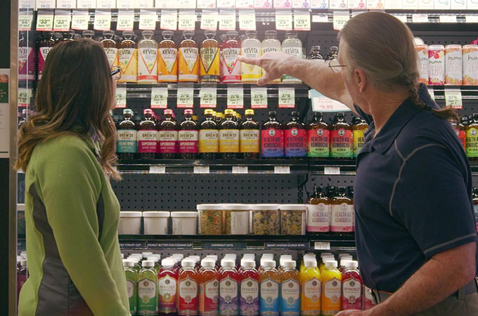 Heinen's Wellness Consultant and Customer Shopping for Kombucha