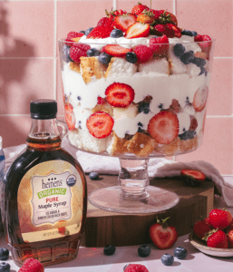 Whipped Yogurt Berry Trifle Beside a Bottle of Heinen's Pure Organic Maple Syrup
