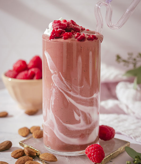 Lion's Mane Shake with Cacao and Raspberries in a Glass with Fresh Raspberries and Almonds