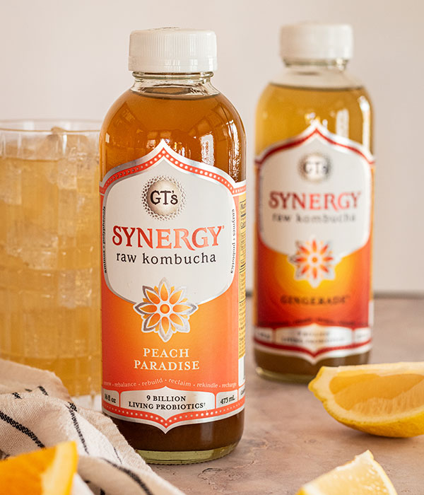 GTs Synergy Kombucha with Orange Slices and a Glass of Kombucha with Ice