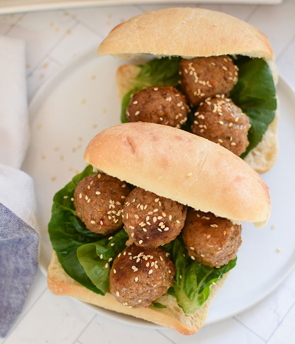 Sweet Chili Meatballs on Ciabatta Buns with Lettuce and Sesame Seeds