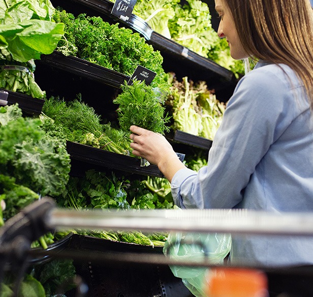 woman with fresh herbs from heinens grocery