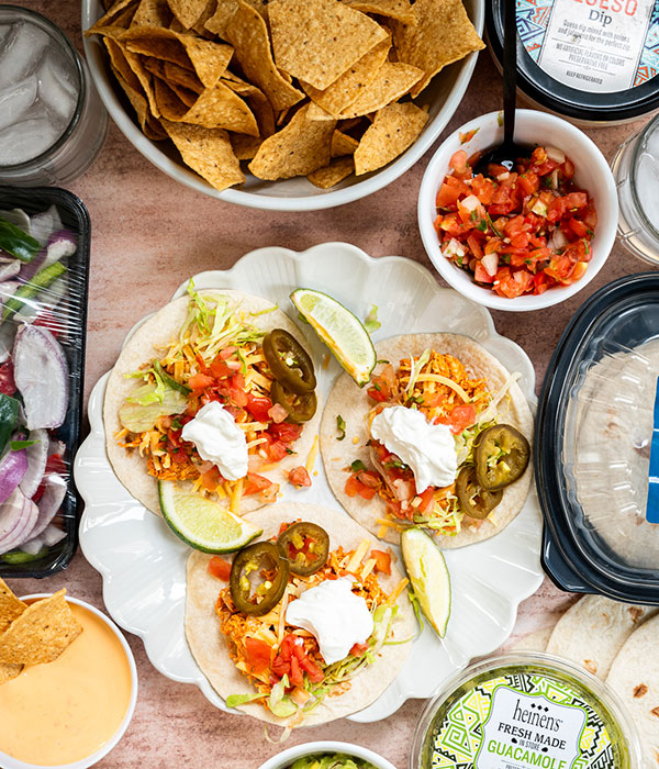 A Plate of Open Tacos Beside an Assortment of Fresh Mexican-Inspired Foods and Drinks