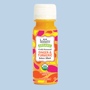 Heinen's Ginger and Turmeric Juice Shot on a Light Blue Background