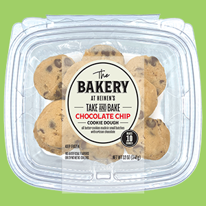 A Package of Heinen's Take and Bake Chocolate Chip Cookies on a Vibrant Green Background