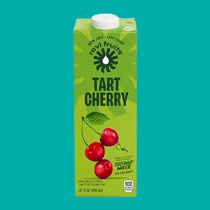 A Carton of Revl Tart Cherry Juice on a Teal Blue Background