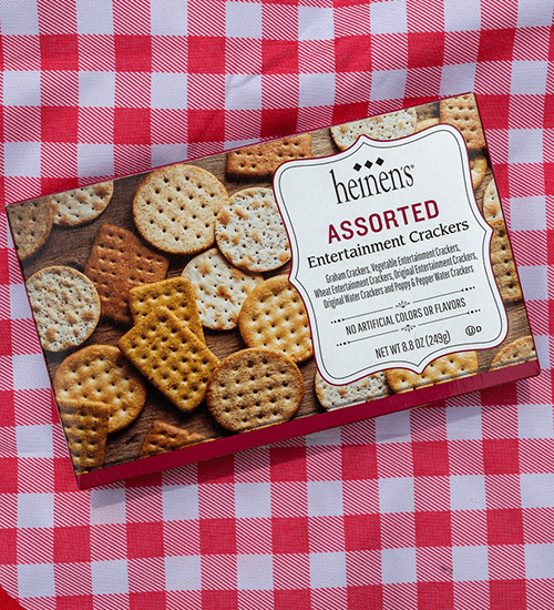 Heinen's Assorted Entertainment Crackers Box on a Red and White Checkered Blanket