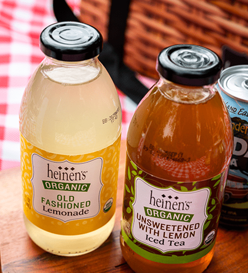 Heinen's Organic Bottled Teas and Lemonades on a Red and White Checkered Blanket
