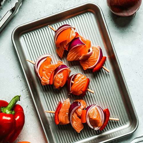 Heinen's Raw Salmon Kabobs on a Metal Sheet Pan