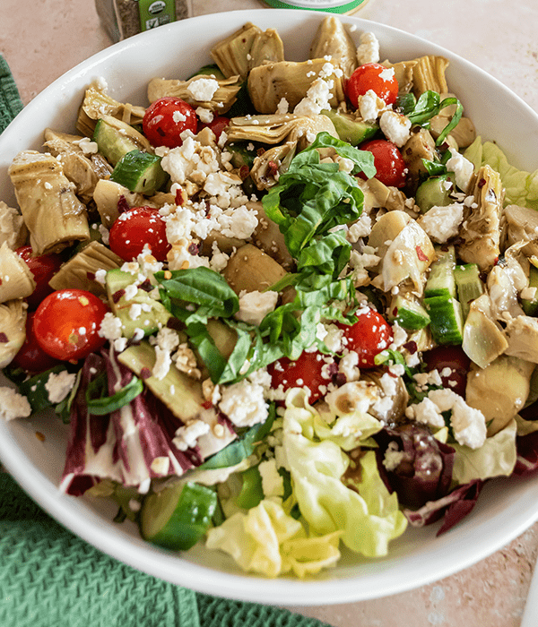 A Close up Image of a Marinated Artichoke Salad in a Serving Bowl