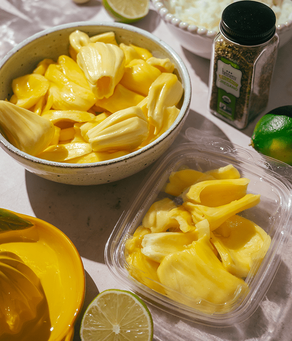 Heinen's fresh-cut jackfruit in a container next to a bowl of jackfruit.