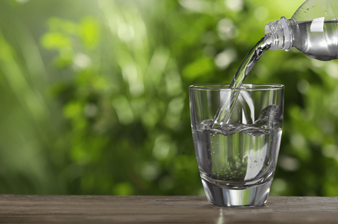 Glass of water being poured