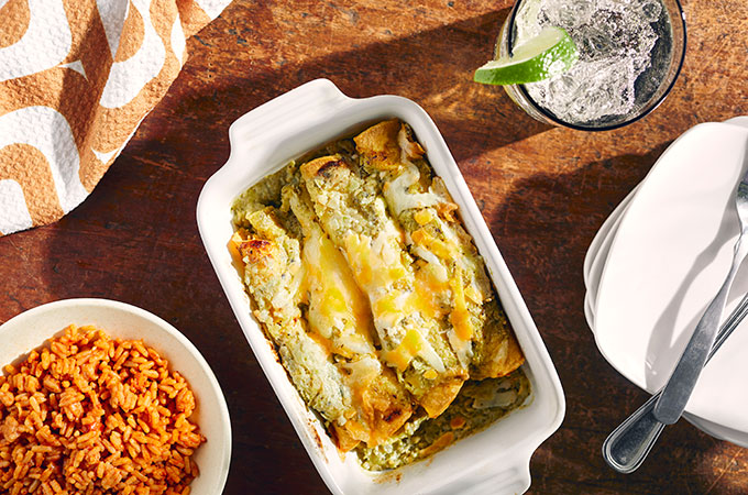 Dish of Chicken Enchiladas Suiza and a bowl of pulled chicken