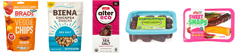 A Bag of Brad's Veggie Chips. A Bag of Biena Chickpea Snacks, a Bar of Alter Eco Chocolate, A Container of Medjool Dates, and a Container of Sweet Snaps Peppers