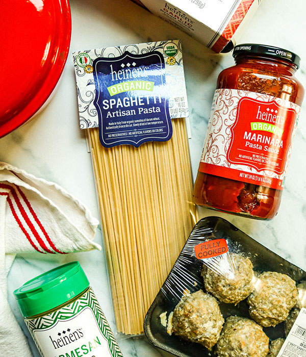 Package of Heinen's Organic Spaghetti Artisan pasta, marinara sauce, meatballs, parmesan cheese, and garlic bread sticks