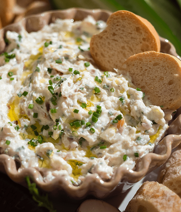 A Close Up Image of Smoked Trout Dip with two Crostini Crackers