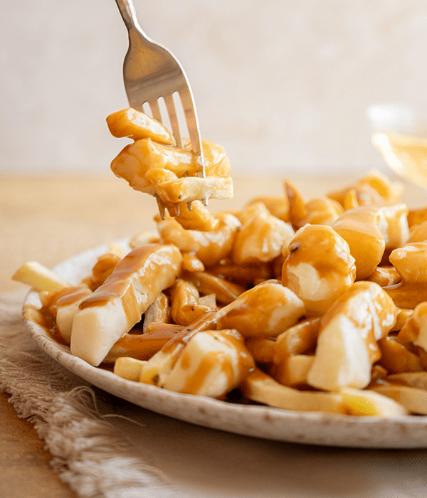 A Fork Picking up a Bite of Classic Poutine