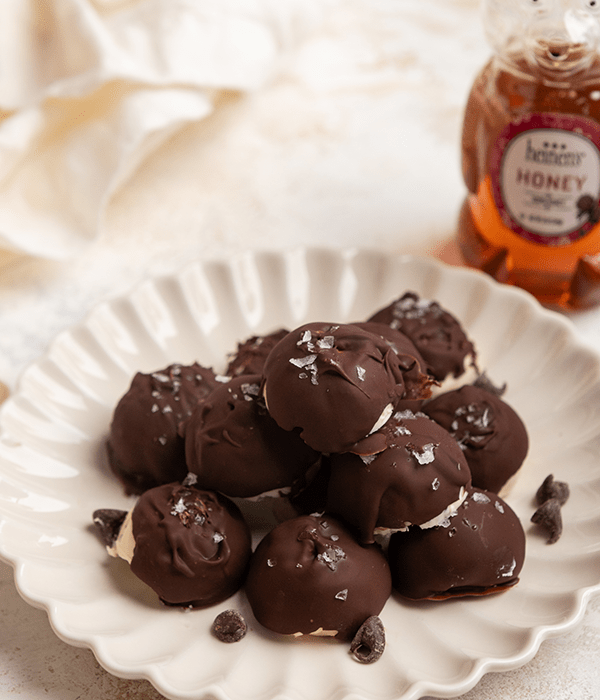 Pile of delicious Frozen Greek Yogurt Bites with a side of honey