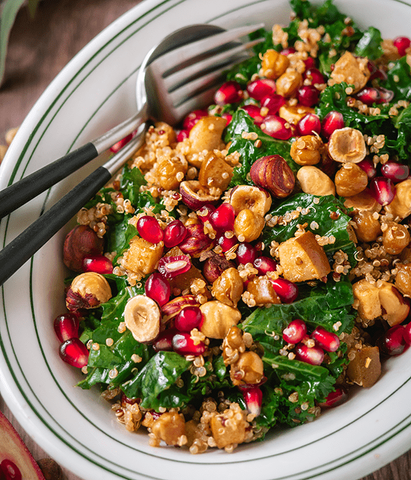 A Serving Bowl of Kale Quinoa Winter Salad with Pears and Pomegranates