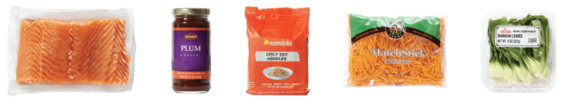 Plum Glazed Salmon Bowl ingredients: Farm Raised Fresh Verlasso Salmon Fillet, Momofuku Spicy Soy Noodles, Dynasty Plum Sauce, Bok Choy & Shanghai Leaves, Matchstick Carrots.