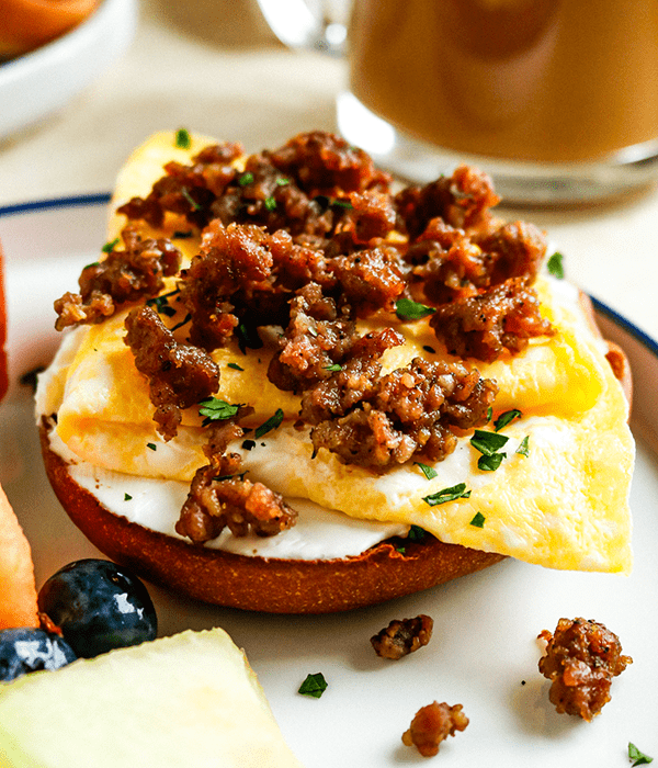 An Open-Face Breakfast Sandwich with Cream Cheese, Eggs, and Cooked and Crumbled Sausage