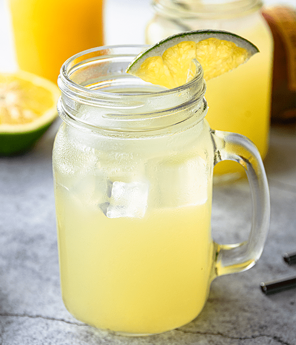 An iced Cocktail Grapefruit Sparkling Punch served in a glass with a slice of Grapefruit on the rim.