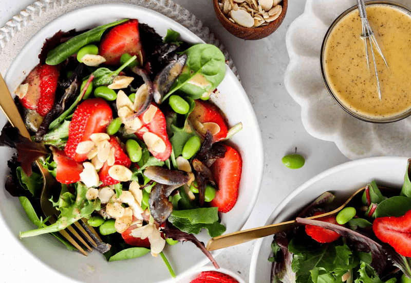 Spring Vegetable Salad with Strawberries and Poppyseed Dressing served with a side of nuts
