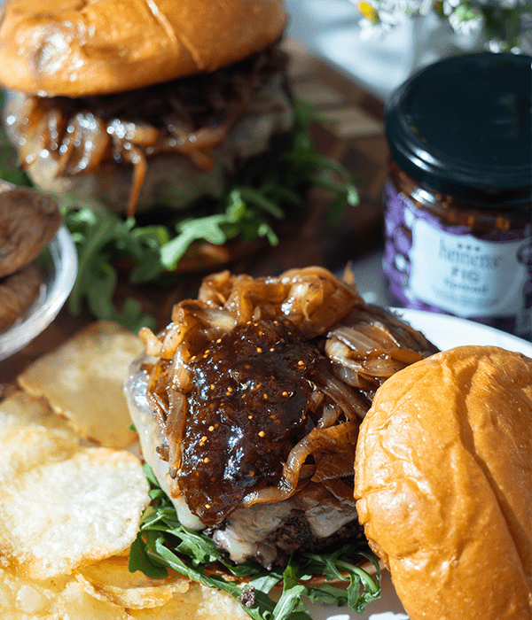 Steakhouse Burger with Fig and Smoked Gouda with the top bun off displaying the fig jam