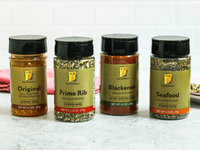 4 bottles of Heinen's 2-Brothers Seasonings that display each flavor we offer