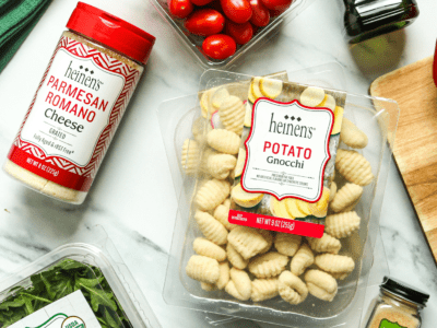 Heinen's Gnocchi and Heinen's brand Parmesan Romano laid out on a table surrounded by other ingredients