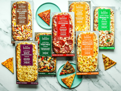 Heinen's 7 styles of frozen flatbread pizzas laid down on a counter