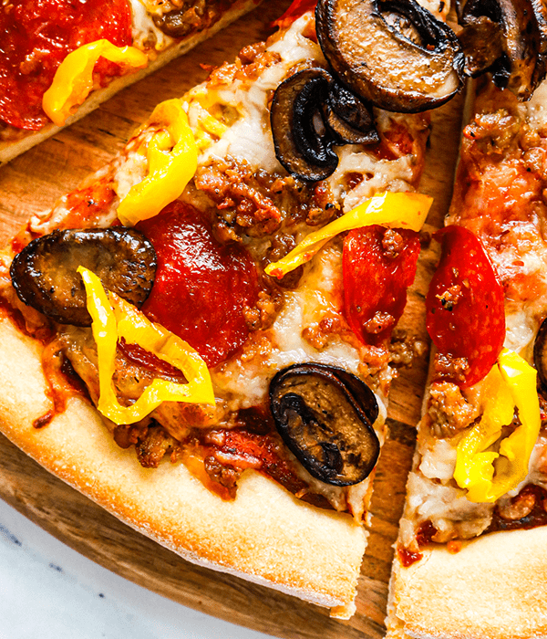 A close up of the topping on the Beer Dough Pizza: including pepperoni, mushrooms, & banana peppers