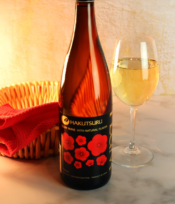 Hakutsuru plum wine bottle next to a glass