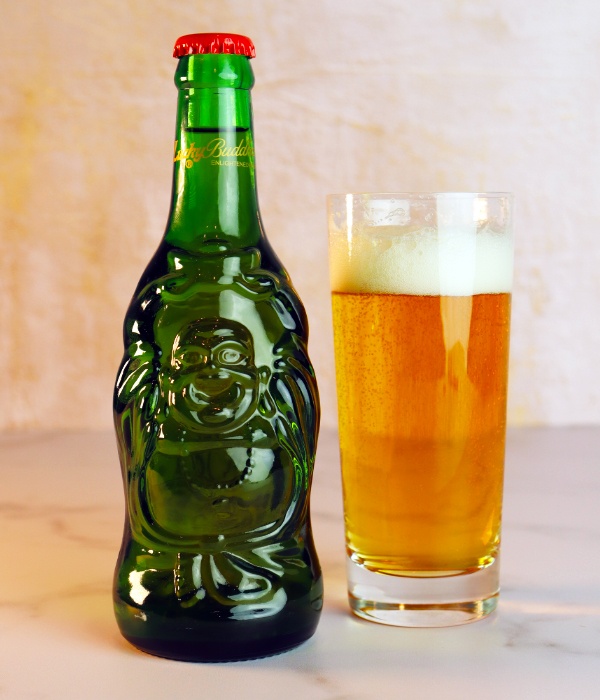 a bottle of Lucky Buddha Beer next to a glass